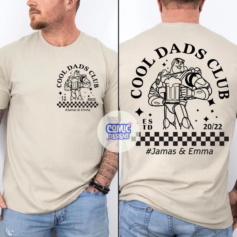 May include: Beige t-shirt with a black graphic of a cartoon character holding a beer mug, with the text "COOL DADS CLUB" and "#Jamas & Emma". The design is on both the front and back of the shirt.