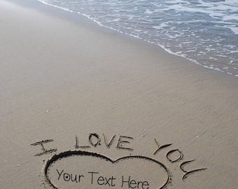 May include: A heart drawn in the sand on a beach with the words "I love you" written above it. The text inside the heart says "Your Text Here".