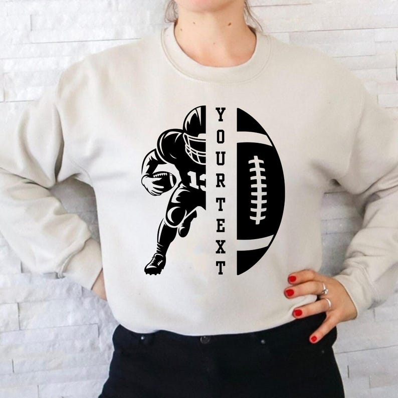 May include: Cream-colored sweatshirt featuring a black graphic of a football player running with a football. The design includes a football with the text "YOUR TEXT" vertically. The player is wearing a helmet and uniform.
