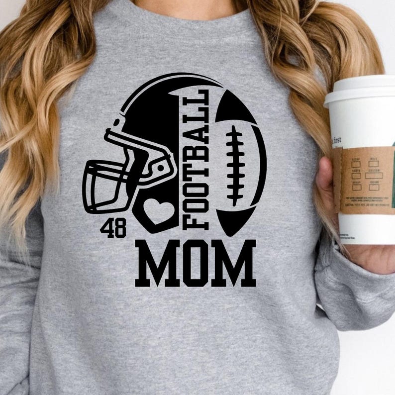 May include: A gray sweatshirt with a black football helmet and football graphic. The word "FOOTBALL" is printed vertically, with "MOM" below. A heart and the number "48" are also included in the design.