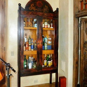 1930’s Spanish Revival Reproduction  solid pine with glass doors.