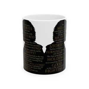 May include: White ceramic mug featuring black silhouettes of two figures with text from a fantasy novel. The text includes phrases like "Stories," "Mr. Frodo," and "Holding on to something." The mug is a literary-themed item.