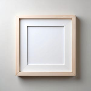 May include: Square wooden picture frame with a white mat. The frame is made of light-colored wood and has a simple, modern design. The mat creates a border around the blank white space, ready for a photo or artwork.
