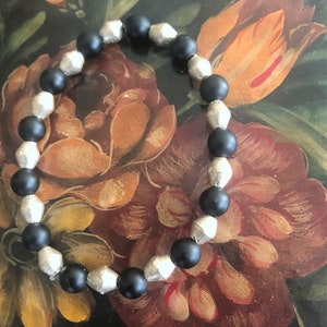 Bracelet. Stretchy. Black beads. Metal spacers. Men. Women. Unisex. Stackable. Trending.