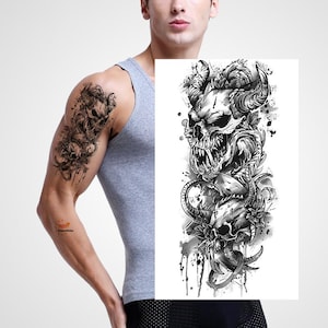 May include: Black and white temporary tattoo featuring a detailed design of demonic skulls with horns and intricate floral and splatter details. The tattoo is a full arm sleeve design, perfect for Halloween or cosplay.