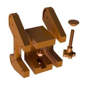 Może przedstawiać: Zdemontowany brązowy zacisk ze śrubą gwintowaną, nakrętką i małą nasadką. Zacisk ma prostokątną podstawę i dwa kątowe ramiona z otworami. Pręt ma uchwyt w kształcie gwiazdy.