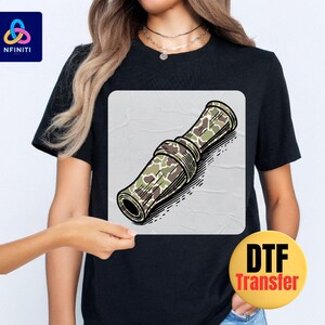 a woman wearing a black t - shirt with a picture of a rolled up rolled