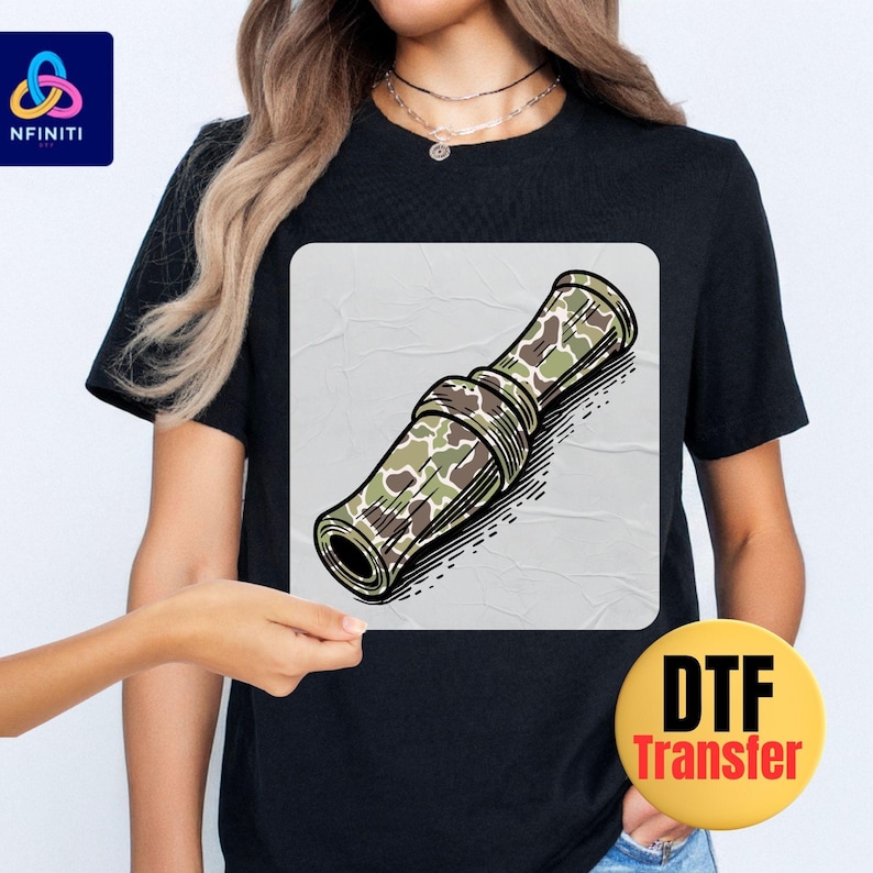 a woman wearing a black t - shirt with a picture of a rolled up rolled