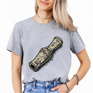 a woman wearing a grey t - shirt with a rolled up rolled up rolled up