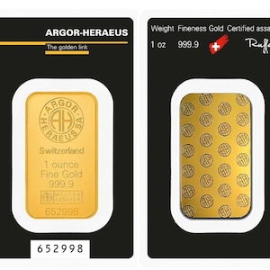 May include: A gold bar, 1 ounce, 999.9 fine gold, in a black and white package. The bar is stamped with the text "ARGOR-HERAEUS Switzerland" and the number "652998". The package also includes the text "The golden link".