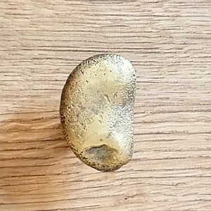 solid brass knobs, each featuring a beautifully unique organic texture. These knobs boast an artisanal, sculptural design that brings a touch of character and charm to modern kitchens, custom furniture, and stylish cabinetry. Crafted from high-quality solid brass, they’re not just built to last; they also add a luxurious feel with their natural golden patina.

brass door handle,
handcrafted handle,
cabinet pull,
solid brass knob,
decorative handle,
antique hardware,
cabinet handle,