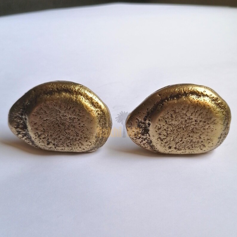 solid brass cabinet knobs, whose earthy, tactile look pays homage to nature's beauty of imperfection. Hand-cast and hand-finished , every piece emerges as a one-of-a-kind sculptural object that is rich with character and antique brass glow.

Brass Handle,
Textured Handle,
Brass Hardware,
Modern Cabinet,
Handmade Handle,
Antique Brass,
Furniture Hardware,
Natural Handle,
Artisan Brass Handle,
Solid Brass Handle,
Kitchen Handle,
Wardrobe Pull Handle,
Brass Knob,