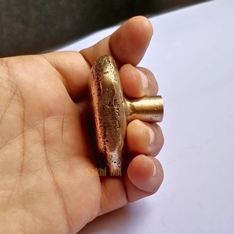 solid brass cabinet knobs, whose earthy, tactile look pays homage to nature's beauty of imperfection. Hand-cast and hand-finished , every piece emerges as a one-of-a-kind sculptural object that is rich with character and antique brass glow.

Brass Handle,
Textured Handle,
Brass Hardware,
Modern Cabinet,
Handmade Handle,
Antique Brass,
Furniture Hardware,
Natural Handle,
Artisan Brass Handle,
Solid Brass Handle,
Kitchen Handle,
Wardrobe Pull Handle,
Brass Knob,