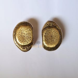 solid brass cabinet knobs, whose earthy, tactile look pays homage to nature's beauty of imperfection. Hand-cast and hand-finished , every piece emerges as a one-of-a-kind sculptural object that is rich with character and antique brass glow.

Brass Handle,
Textured Handle,
Brass Hardware,
Modern Cabinet,
Handmade Handle,
Antique Brass,
Furniture Hardware,
Natural Handle,
Artisan Brass Handle,
Solid Brass Handle,
Kitchen Handle,
Wardrobe Pull Handle,
Brass Knob,