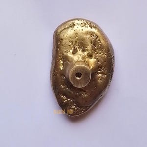 solid brass cabinet knobs, whose earthy, tactile look pays homage to nature's beauty of imperfection. Hand-cast and hand-finished , every piece emerges as a one-of-a-kind sculptural object that is rich with character and antique brass glow.

Brass Handle,
Textured Handle,
Brass Hardware,
Modern Cabinet,
Handmade Handle,
Antique Brass,
Furniture Hardware,
Natural Handle,
Artisan Brass Handle,
Solid Brass Handle,
Kitchen Handle,
Wardrobe Pull Handle,
Brass Knob,