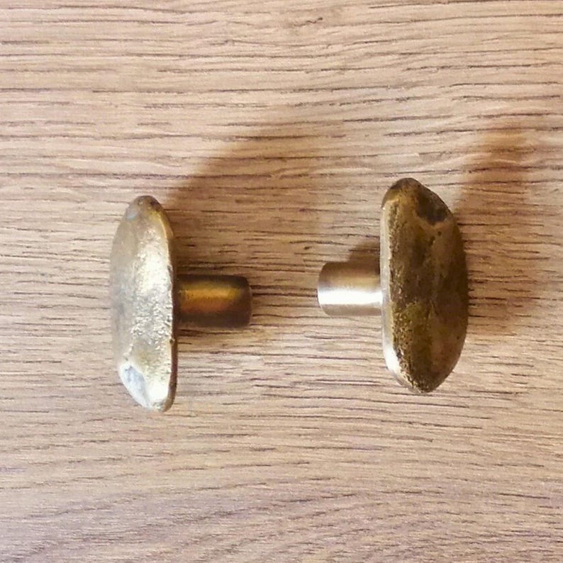 solid brass knobs, each featuring a beautifully unique organic texture. These knobs boast an artisanal, sculptural design that brings a touch of character and charm to modern kitchens, custom furniture, and stylish cabinetry. Crafted from high-quality solid brass, they’re not just built to last; they also add a luxurious feel with their natural golden patina.

brass door handle,
handcrafted handle,
cabinet pull,
solid brass knob,
decorative handle,
antique hardware,
cabinet handle,