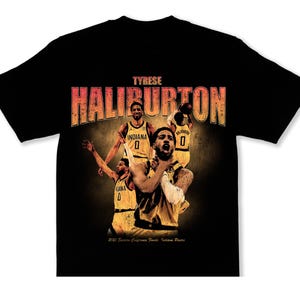 May include: Black t-shirt featuring a graphic of Tyrese Haliburton and other basketball players in yellow uniforms. The text "TYRESE HALIBURTON" is displayed in orange and red. The shirt has a vintage, distressed look.