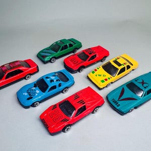 Lot of 7 Vintage Die-Cast Toy Cars – 1980s/1990s – Mixed Colors & Designs