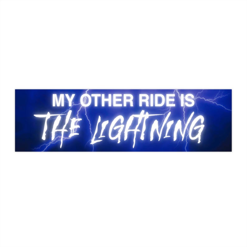 May include: A rectangular bumper sticker with a blue background and white text that reads "MY OTHER RIDE IS THE LIGHTNING." Lightning bolt graphics are on the right and left sides of the text.