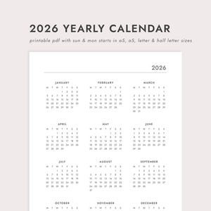 May include: A printable 2026 yearly calendar in a minimalist design. The calendar is white with black text, featuring the year at the top and monthly grids. The text "2026 YEARLY CALENDAR" is at the top.