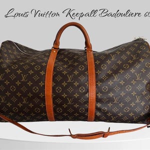 May include: A brown and tan Louis Vuitton Keepall Bandouliere 60 travel bag with a monogram pattern. The bag has a top handle and a long shoulder strap.