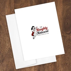 May include: White notecard with a red and black graphic of a woman holding a letter, with the text "The Naughty Notecard". The card is paired with a white envelope. The background is a wooden surface.