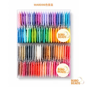 May include: A clear plastic storage box containing 96 individual small pouches of colorful beads, arranged in a gradient spectrum. The text MARD96 and the BOBO BEADS logo are visible on the packaging. The beads display a wide range of hues.