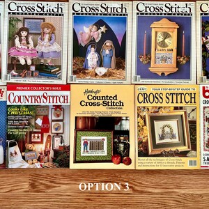 May include: A collection of ten cross stitch magazines with various themes, including Christmas, counted cross stitch, and fairy tales. The magazines are arranged in two rows on a wooden surface. The text on the covers includes "Cross Stitch", "Country Stitch", "Cross Quick", "Counted Cross-Stitch Collection", and "Special Burda Cross-Stitch Series from Anna".