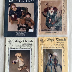 May include: Four different sewing patterns for cloth dolls. The patterns are titled "Dream Spin Late Edition", "Sweet Sugar Ragtown #405", "Magic Threads Angel Hair", and "Magic Threads Widgets".