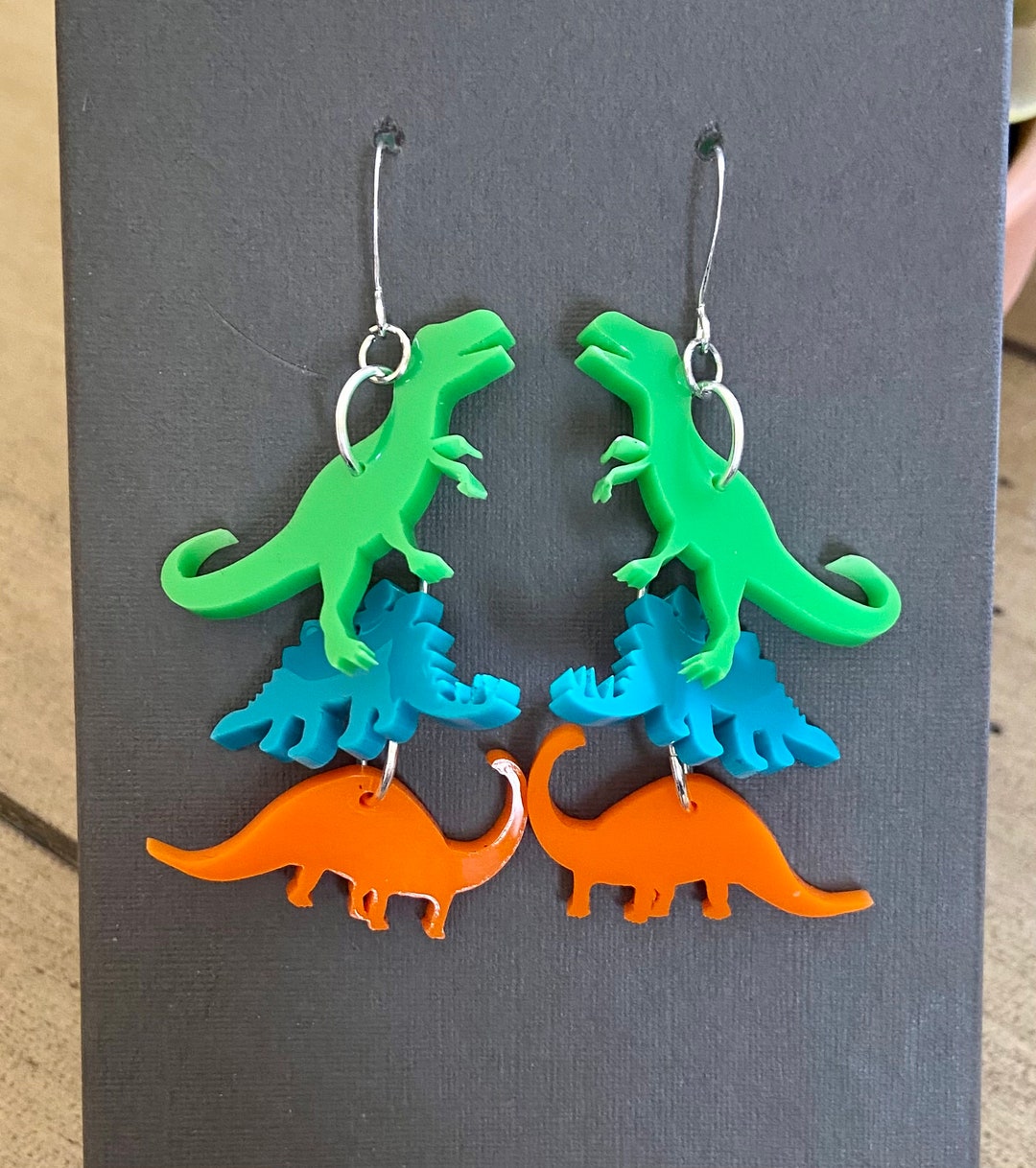 Cascade of Dinosaur Earrings. Laser Cut Acrylic. Shop Name Etsy