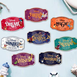 May include: A collection of Disney-themed stickers with various words like "Dream," "Fantasy," and "Magic." Each sticker features Disney characters and the text "July 15-2026 The Smith Family" in a decorative frame. The stickers are colorful and eye-catching.