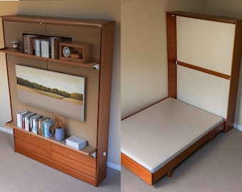 May include: A wall-mounted Murphy bed with a wooden frame and a white mattress. The bed is folded up and has a shelf above it with books and a clock. The bed is in a room with beige walls.