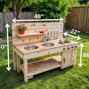 May include: A wooden outdoor play kitchen, 48 inches wide, 40 inches tall, and 22 inches deep. It features two stainless steel sinks, a shelf, and a cabinet. Includes pots, pans, and utensils. The height is 26 inches. A fun toy for kids.