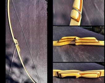 Longbow, Maple core with custom handmade Walnut and maple Layers for Handle and Nocks. Shoots 46# @ 29" draw. 72" Tall