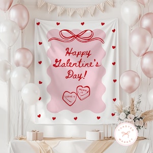 May include: A Valentine's Day banner with the text "Happy Galentine's Day!" in red script. The banner is pink with a scalloped edge and red heart accents. White and pink balloons and a floral arrangement decorate the scene.