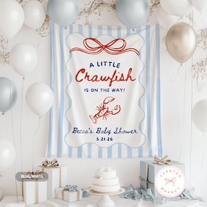 May include: A baby shower backdrop with the text "A Little Crawfish Is On The Way!" in red and blue. The backdrop has a scalloped border and a lobster graphic. White and blue balloons decorate the background. The event is for Becca, with the date 5.21.26.