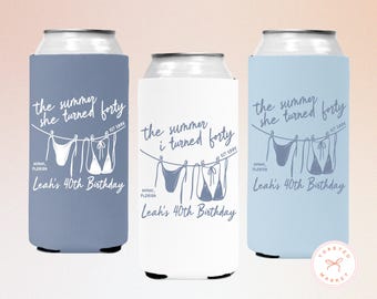 May include: Three can coolers in blue and white, each with a different design. The text reads "the summer she turned forty" and "the summer i turned forty" with "Leah's 40th Birthday" and "Miami, Florida" below.