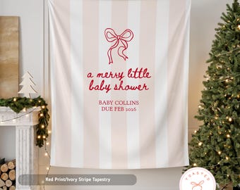 May include: A red and ivory striped tapestry with the text "a merry little baby shower" and "BABY COLLINS DUE FEB 2026". A red bow graphic is above the text. The tapestry is hanging in a room with a Christmas tree.