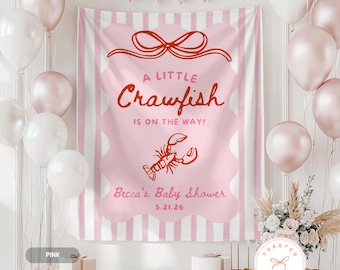May include: A pink baby shower banner with the text "A Little Crawfish Is On The Way!" and a crawfish illustration. The banner is decorated with pink and white balloons, and a floral arrangement. The event is for Becca, on 5.21.26.