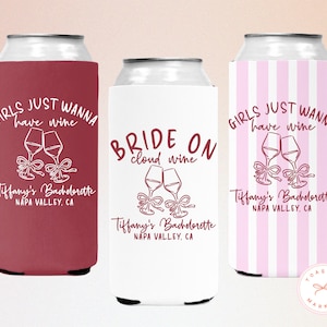 May include: Three can coolers with wine-themed text and graphics. One is burgundy with "Girls Just Wanna Have Wine", another is white with "Bride on cloud wine", and the third is pink striped with "Girls Just Wanna Have Wine".