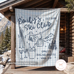 May include: A light blue and white gingham tapestry with the text "Emily's Ski Club EST 2026". The design includes ski equipment, a ski lift, mountains, and champagne. The text "Emily's Bachelorette Vail, CO" is also included.