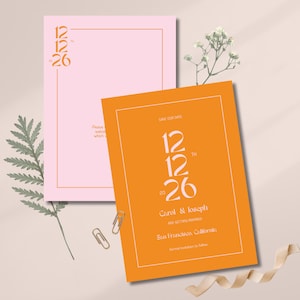 Peut inclure: Deux cartons d'invitation de mariage, un rose et un orange, avec la date "12/26" dans une police élégante. La carte orange comprend les noms "Carol & Joseph" et le lieu "San Francisco, Californie".