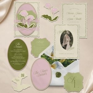 May include: A wedding stationery suite featuring cream, sage green, and soft pink cards with scalloped edges. Includes an oval invitation with a couple's photo, a details card, an RSVP card with a QR code, and an envelope with a wax seal.