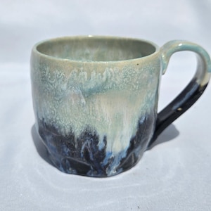Blue, black, and white hand thrown coffee mugs