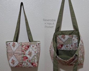 May include: Reversible tote bag with a patchwork floral design in pink, white, and green. The bag has olive green straps and interior lining. The text on the image reads "Reversible + Has A Pocket!"