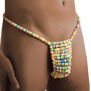 Pode incluir: Um fio dental de fantasia feito de doces redondos multicoloridos. A corda do fio dental e a seção frontal são feitas dos mesmos doces. Os doces são em tons de amarelo, rosa, azul, verde e laranja.