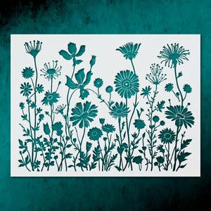 May include: A rectangular stencil featuring a detailed cutout design of various wildflowers and meadow plants. The pattern displays a dense arrangement of stems, leaves, and diverse flower heads in a teal color against a white background.