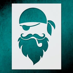 May include: A white stencil featuring a teal pirate design. The design includes a pirate hat, eye patch, mustache, beard, and a pipe. The stencil is on a teal background.