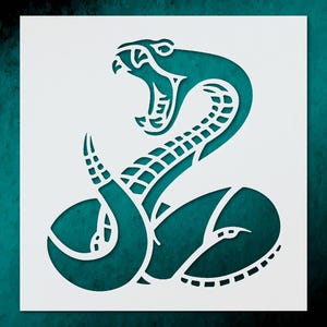 May include: A teal snake stencil with an open mouth and detailed scales. The snake is coiled, with a stylized design. The stencil is cut out of white material, creating a negative space effect. The background is a gradient of teal.