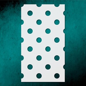 May include: A white rectangular stencil with evenly spaced, circular cutouts. The stencil is set against a teal-colored, textured background. The cutouts are a darker shade of teal, creating a contrasting pattern.